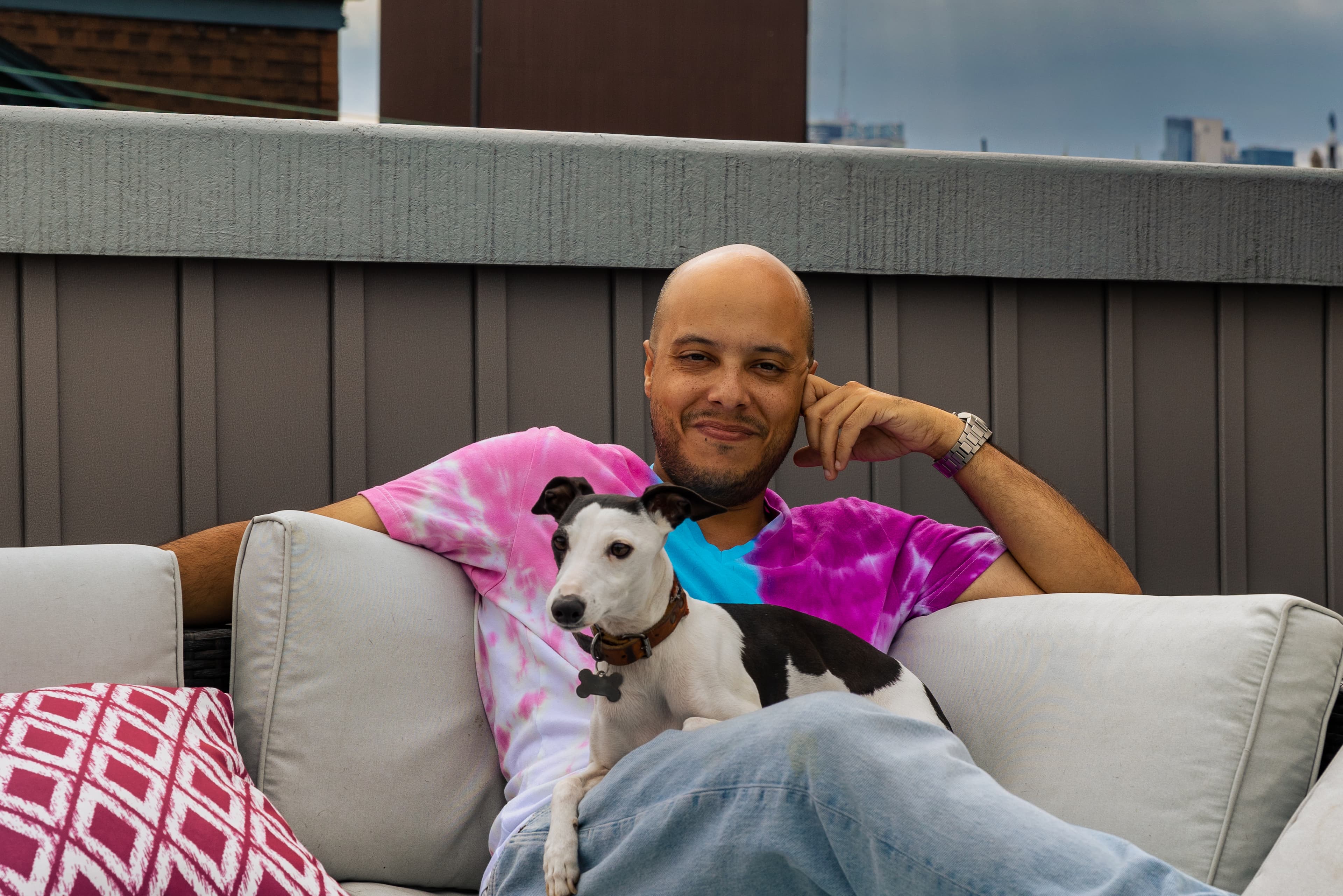 photo of orlando and churro, sitting outside in philly on a cloudy day.